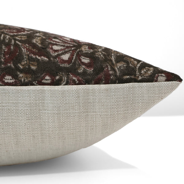 Side view of handcrafted floral block print pillow cover with dark maroon, beige, and white pattern on black fabric — neutral linen backing by Hackner Home.
