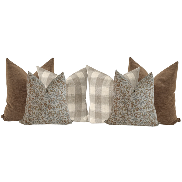 Set of six decorative pillows in warm neutral tones featuring solid brown, beige plaid, and blue floral block print designs arranged in a cohesive styling group.