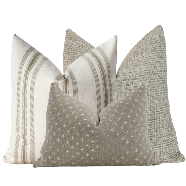 Set of four decorative pillow covers in soft sage and neutral tones, featuring a mix of solid textures, subtle stripes, and small geometric patterns arranged together.
