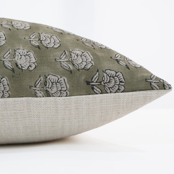 Side view of handcrafted green floral block print pillow cover with white flower pattern and neutral linen backing — artisan decorative cushion by Hackner Home.