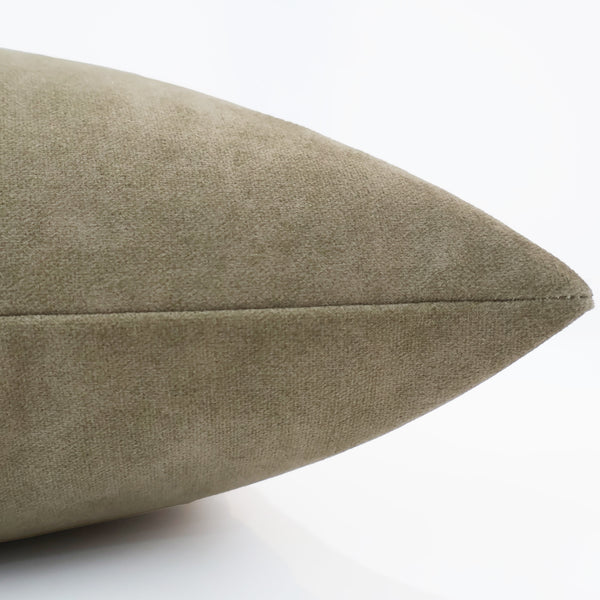 Close-up side view of a vintage suede pillow cover in olive green, showing its soft texture and clean seam detail.