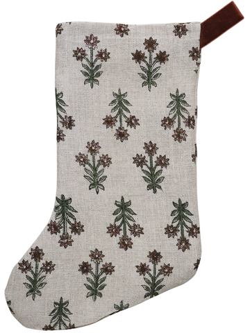 Hackner Home Wood Lily Block Print Christmas Stocking featuring a hand-printed floral design in earthy green and brown tones on a natural linen fabric, accented with a brown velvet hanging loop for a warm, boho-inspired holiday look.